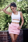 REBELLA CUT YOU OFF, FRONT CUT OUT, RIB KNIT CROPPED TANK TOP IN WHITE- FRONT VIEW- PAIRED WITH A DENIM SKIRT